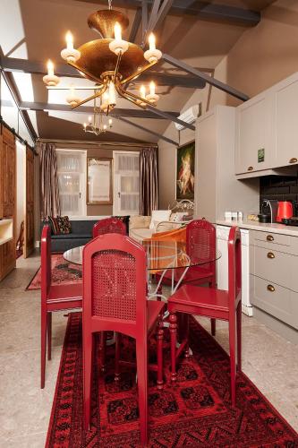a dining room with a red table and chairs at Faik Pasha Hotels Special Category Beyoglu Istanbul in Istanbul