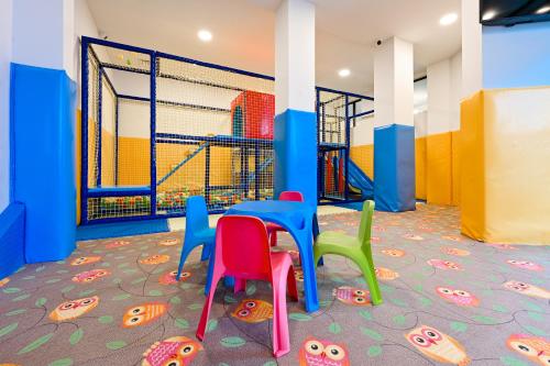 a childrens play area with a table and chairs at Grand Hotel Velingrad in Velingrad
