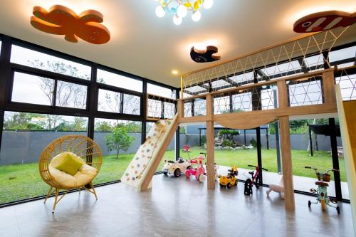 a room with a playroom with a slide and toys at 和你民宿 in Xincheng