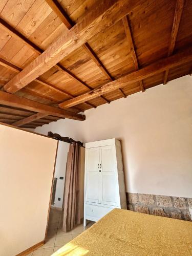 a bedroom with a bed and a wooden ceiling at Podere La Branda in Vetralla
