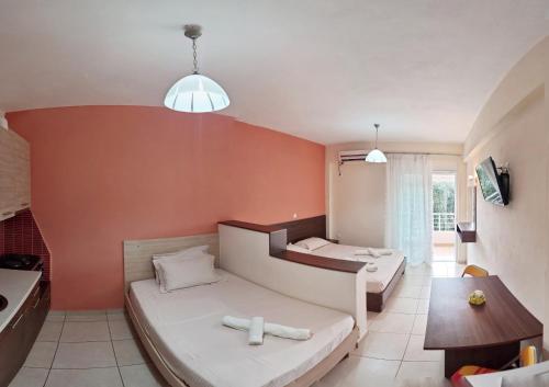 a hotel room with two beds and a table at Studio Beleri in Himare