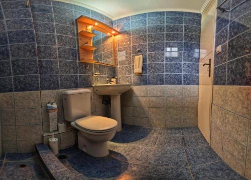 a bathroom with a toilet and a sink at Studio Beleri in Himare