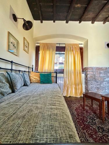 a bedroom with a large bed and a window at Podere La Branda in Vetralla