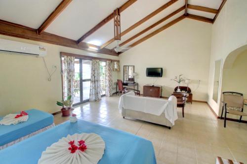 a living room with two beds and a couch at Honiara Hotel in Honiara