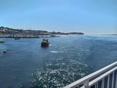 a boat in a large body of water next to a bridge at Port Lodge Northern Ireland in Portaferry