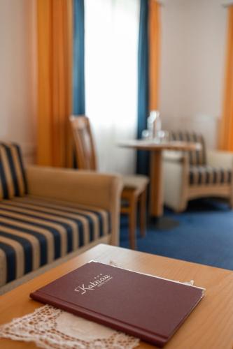 a menu on top of a table in a room at Hotel Garni Katnau in Schenna