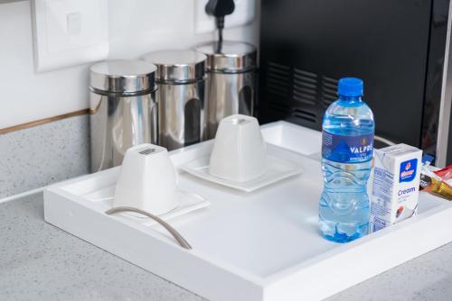 a bottle of water sitting on a kitchen sink at Moonpopson Luxury Apartments, Fourways Sandton in Sandton