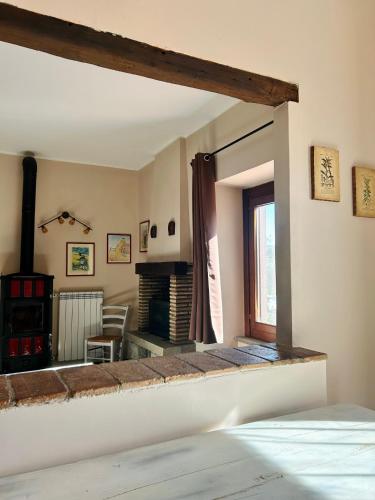 a room with a fireplace and a bedroom with a bed at Podere La Branda in Vetralla