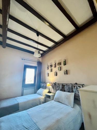 a bedroom with two beds and a window at Podere La Branda in Vetralla