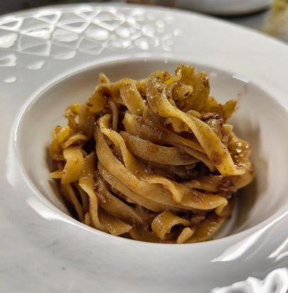 a white bowl filled with pasta on a plate at Albergo Torre in Vicenza