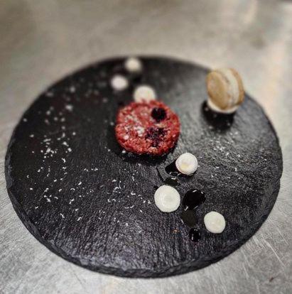 a black rock with a redastery on top of it at Albergo Torre in Vicenza