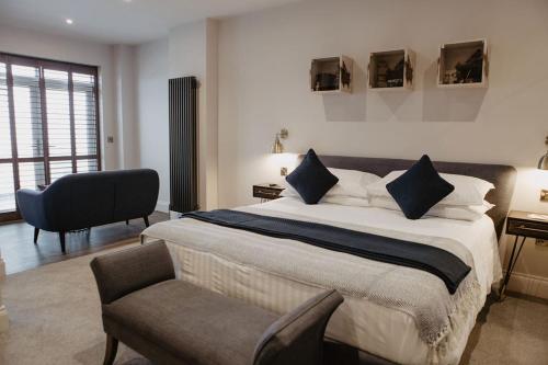 a bedroom with a large bed and a chair at The Woolacombe Bay Hotel in Woolacombe
