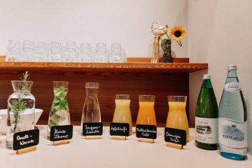 a group of bottles and glasses on a shelf at Hotel Garni Katnau in Schenna