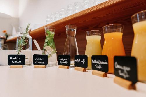 a row of glasses and bottles of orange juice at Hotel Garni Katnau in Schenna