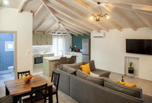 a living room with a couch and a table at Kamari Luxury Apartment in Lefkada Town