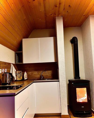 a kitchen with a stove in the corner of a room at Villa Dardania in Peje