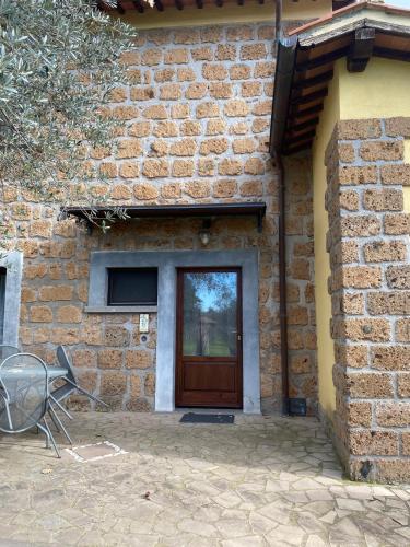 a door of a brick building with a chair in front of it at Podere La Branda in Vetralla