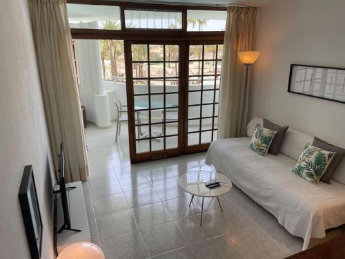 a living room with a couch and a table at Apartment PM237 - Paraiso Maspalomas in Playa del Ingles
