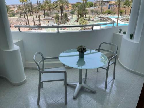 a table and two chairs in a room with a window at Apartment PM237 - Paraiso Maspalomas in Playa del Ingles