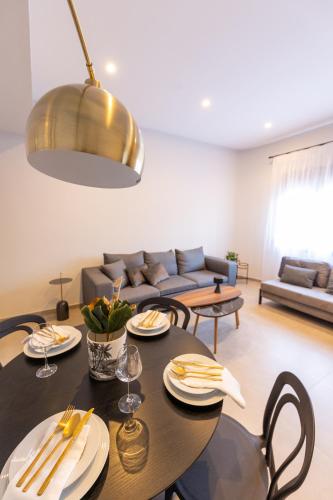 a living room with a table and a couch at Kaleo Chios Luxury Apartments in Chios