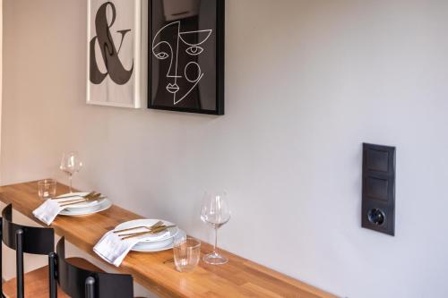 a dining room with a wooden table with chairs at Kaleo Chios Luxury Apartments in Chios