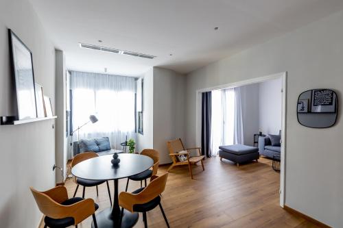 a living room with a table and chairs at Kaleo Chios Luxury Apartments in Chios