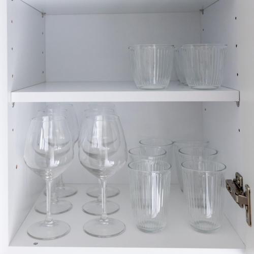 a bunch of wine glasses sitting on a shelf at Kaleo Chios Luxury Apartments in Chios