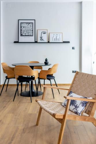 a dining room with a bench and a table at Kaleo Chios Luxury Apartments in Chios