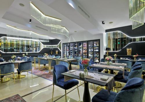 a restaurant with tables and chairs and a wine cellar at Epoque Hotel - Relais & Chateaux in Bucharest