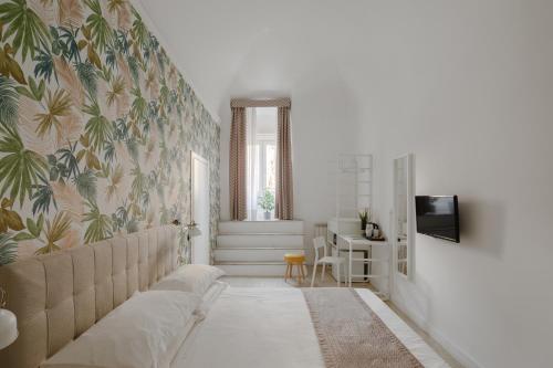 a living room with a couch and a wall mural at Trevi Fountain Guesthouse in Rome