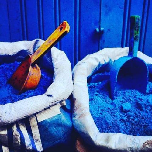 a wooden baseball bat in a basket in the sand at Casa Plasa Grande in Chefchaouene
