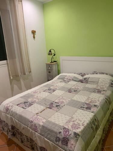 a bedroom with a bed with a quilt on it at Villa Melissa in Diano Castello