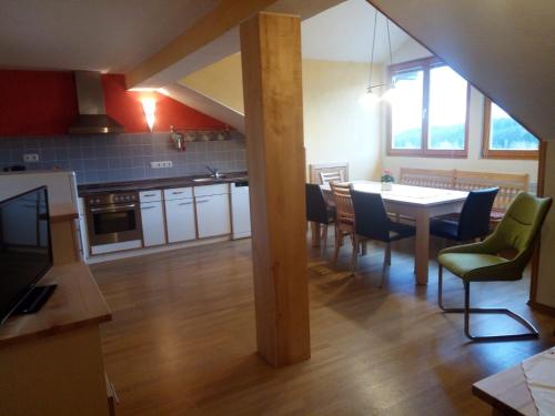 a kitchen and dining room with a table and chairs at Ferienwohnung Haus Hollerbusch in Zwiesel