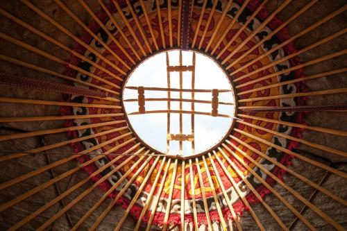 una ventana redonda en una iglesia con una cruz en Nomadic Life in a yurt, en Bügat