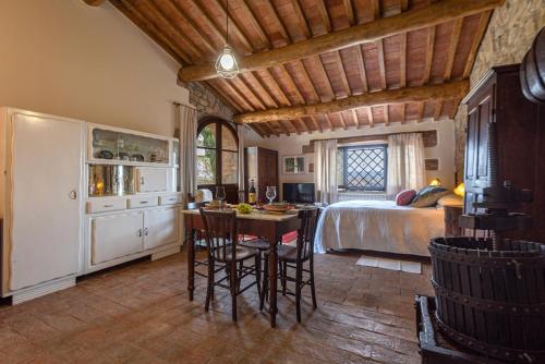 a bedroom with a bed and a table and chairs at Podere Colombaio - Bucaneve in Radicofani