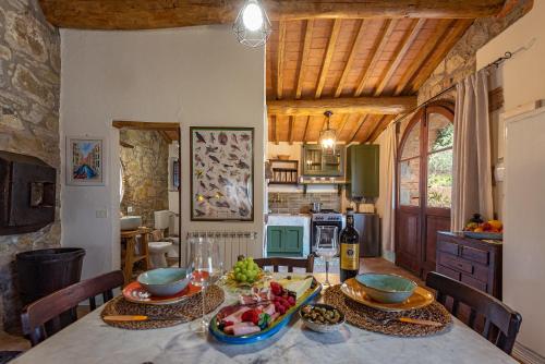 a kitchen with a table with bowls of food on it at Podere Colombaio - Bucaneve in Radicofani
