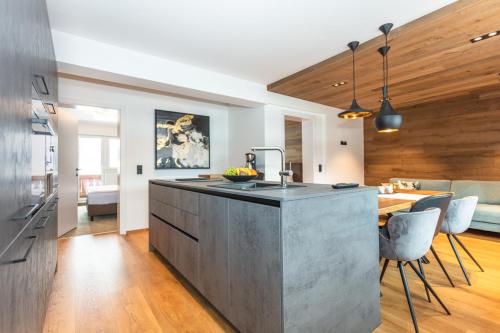 a kitchen with a large island in the middle of a room at lechner living apartments in Wald im Pinzgau