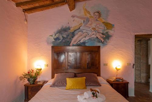 a bedroom with a painting of a angel on the wall at Podere Colombaio - Verbena in Radicofani