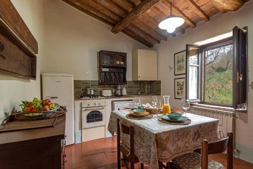 a kitchen with a table with a table cloth on it at Podere Colombaio - Verbena in Radicofani