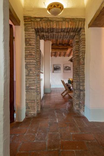 a hallway in a building with a stone wall at Podere Colombaio - Verbena in Radicofani