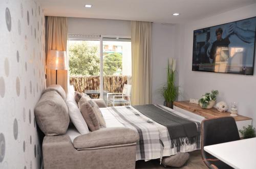 a bedroom with a bed and a couch at Apartamento Sofia in Pineda de Mar