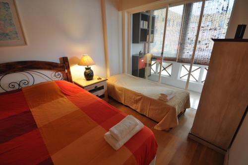 a hotel room with two beds and a window at Apart Lisbon Pool Metro Garage in Lisbon