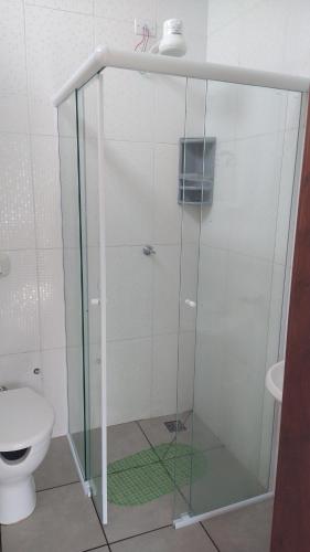 a glass shower in a bathroom with a toilet at Espaço coração de mãe in Pirapòzinho