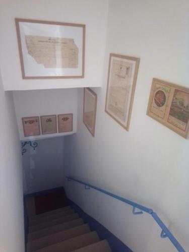 a stairway with stairs and pictures on the wall at Piccola Casa Di Sardegna in Villanova Monteleone