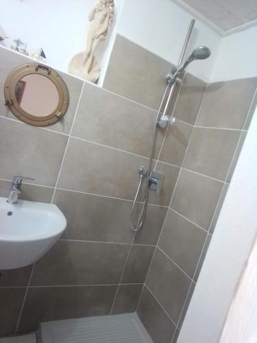 a bathroom with a shower and a sink at Piccola Casa Di Sardegna in Villanova Monteleone