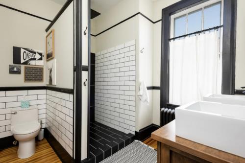 a bathroom with a toilet and a sink at Hudson Valley Retreat in Downtown Hudson, NY - Sleeps 16-20 in Hudson