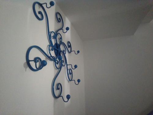 a metal wall art with music notes on a wall at Piccola Casa Di Sardegna in Villanova Monteleone