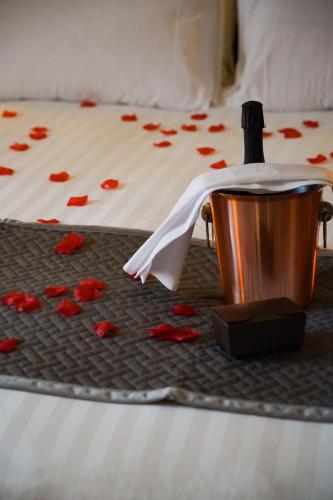 a bed with a tray with a bottle of wine and a towel at Great North Hotel in Newcastle upon Tyne