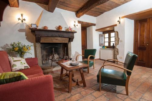 a living room with a couch and a fireplace at Pilari Intera struttura in Corgna