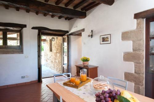 a dining room with a table with fruit on it at Pilari Intera struttura in Corgna